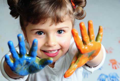 Little girl playing with colors
